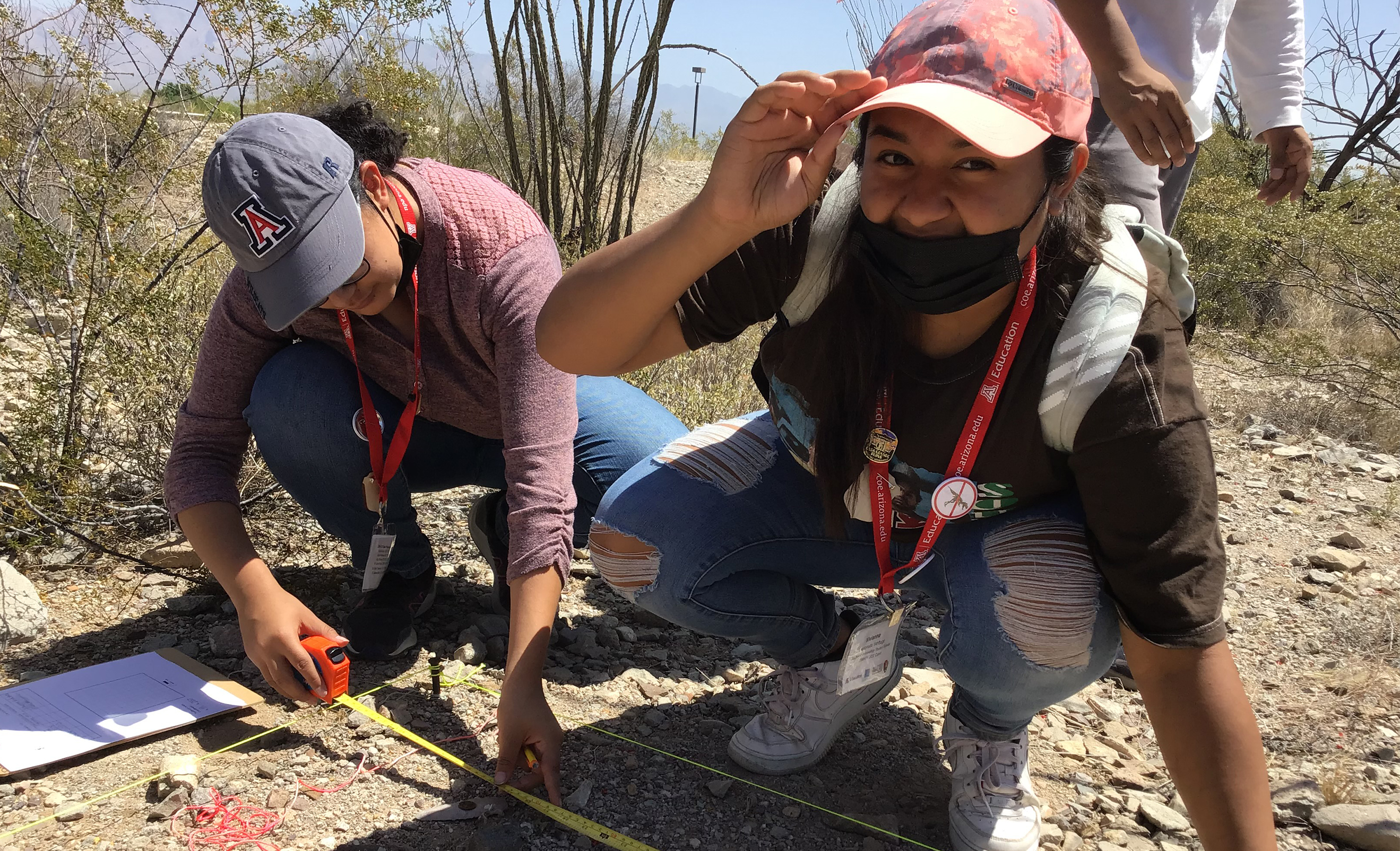 two students working in the sands of cliff new mexico